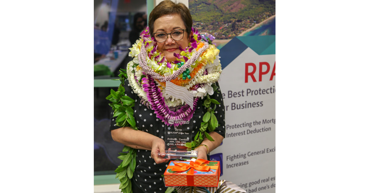Photo of REALTOR® Broker, Arabel Camblor, receiving the 2019 REALTOR® of the Year award from Hawaii Association of REALTORS®
